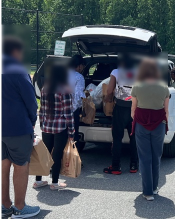 Volunteers dropping off donated goods at a community collection point