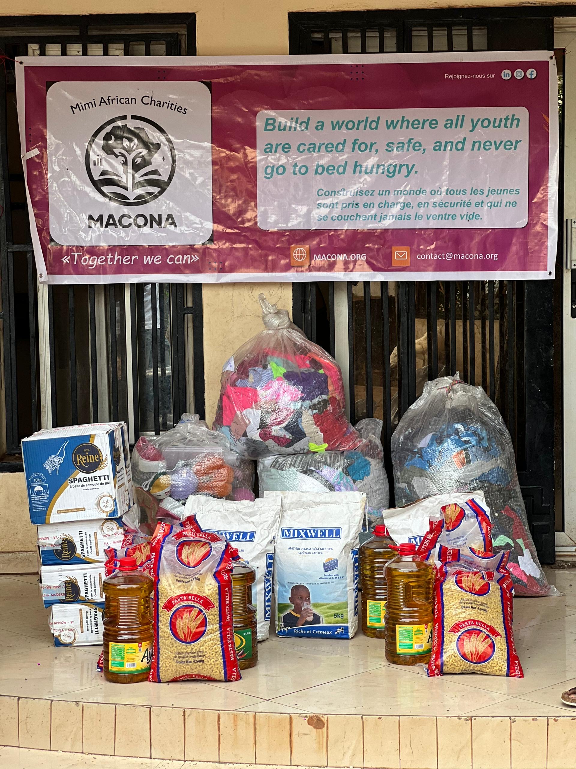 Donated goods gathered under the MACONA banner at a community distribution