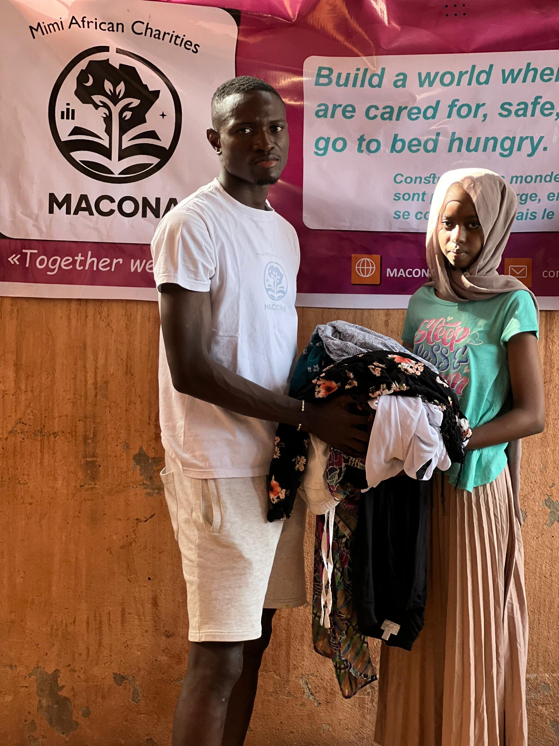 Staff helping a young girl with clothes