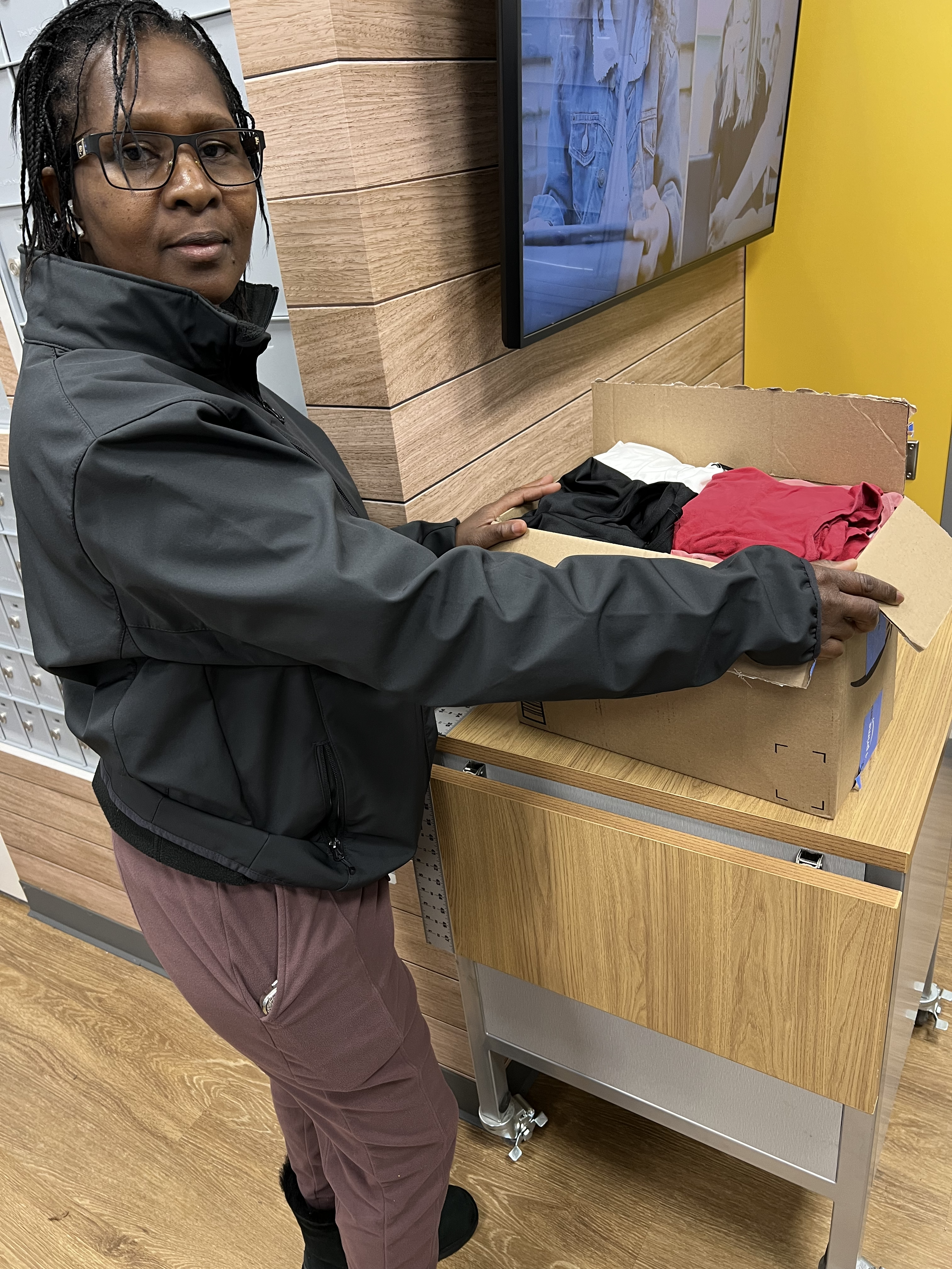 Mimi Williams with a box of clothes for donation